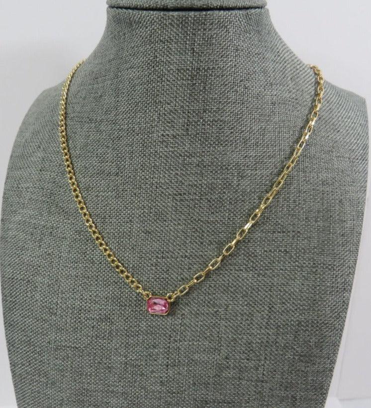 bright stone necklace in pink with gold chains of 2 different styles on a necklace mannequin on a white background